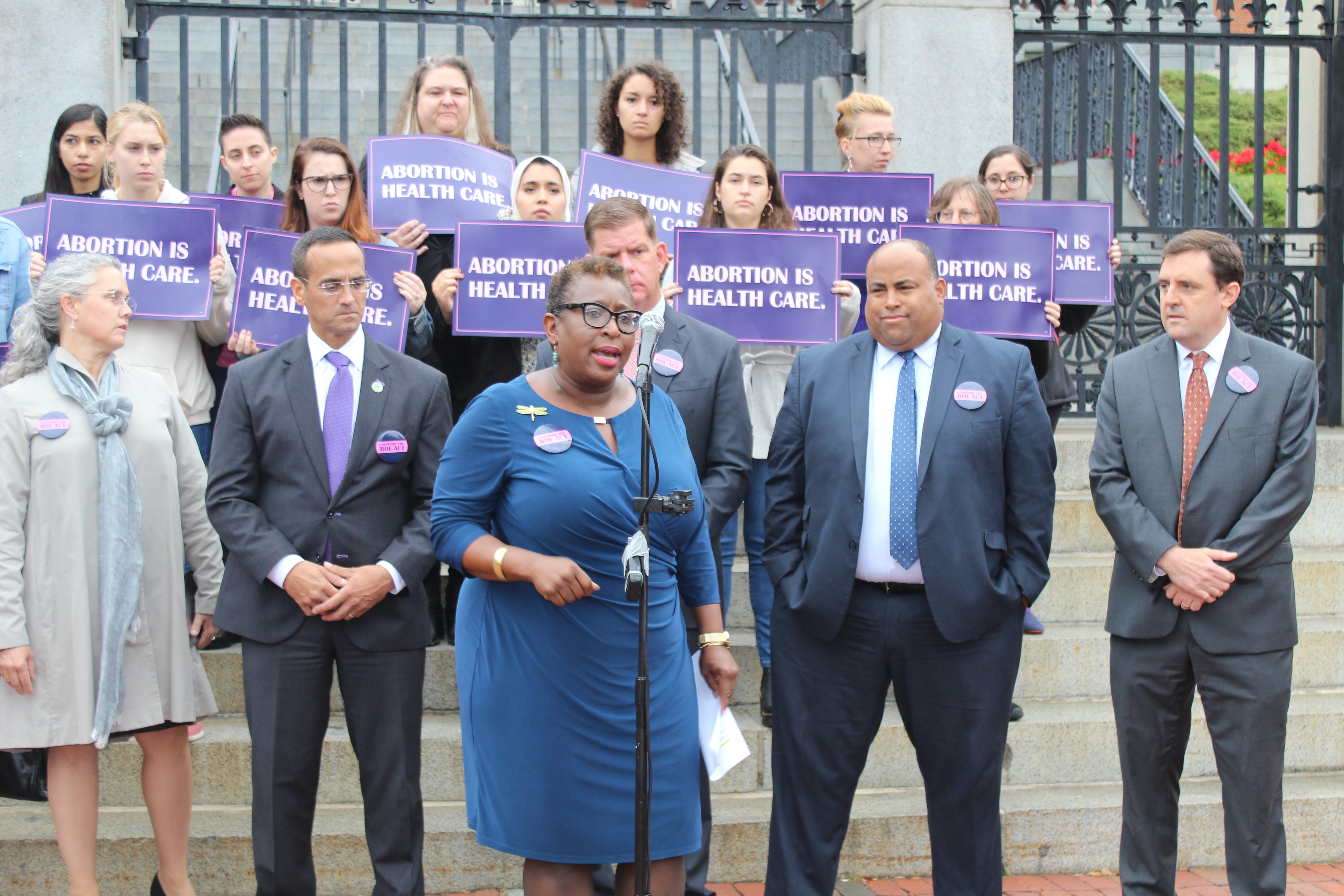(From left to right) Mayors Nicole LaChapelle of Easthampton, Joseph Curtatone of Somerville, Martin Walsh of Boston, Daniel Rivera of Lawrence and Marc McGovern of Cambridge, stood behind Mayor Yvonne Spicer of Framingham while she spoke of the impact this bill would have on the health care received by women of color in Massachusetts. Photo by Catherine McGloin.