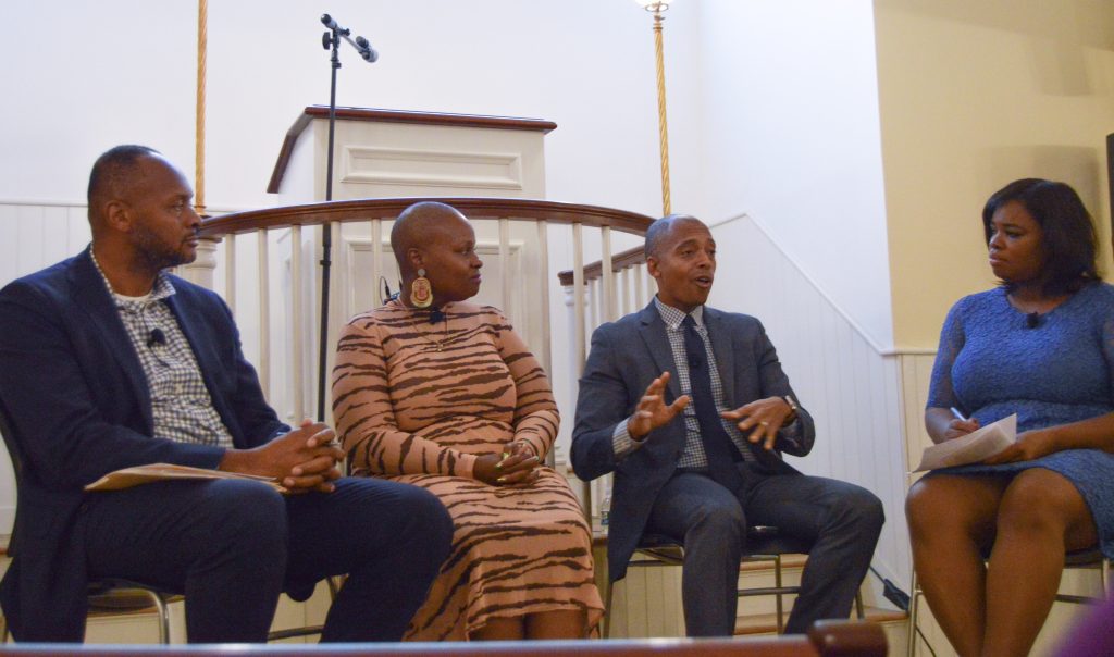 (Left to right) Michael Curry, Keeonna Harris, Khalil Muhammad and panel moderator, Tina Martin, discuss closing the gap between communities and policy makers. Photo by Bryan Tan.