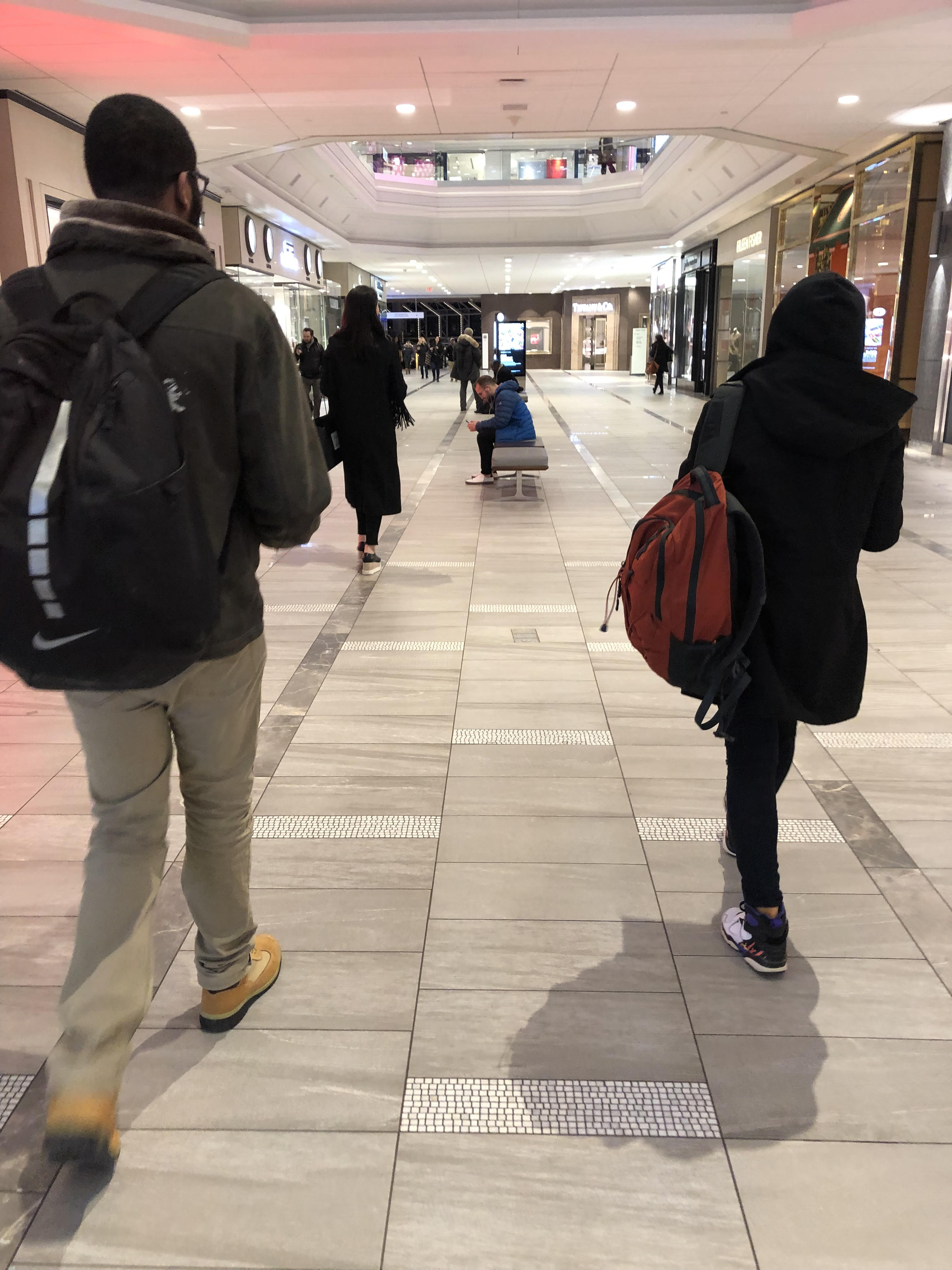 Young, a member of Everyday Boston, walks through Copley Place Mall handing out Valentine’s Day cards to strangers. Photo by Sumya Mohiuddin.
