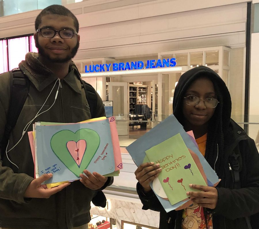 Young and a friend hand out Valentine’s Day cards to strangers in the Copley Place Mall. Young is a member of Everyday Boston. Photo by Sumya Mohiuddin.