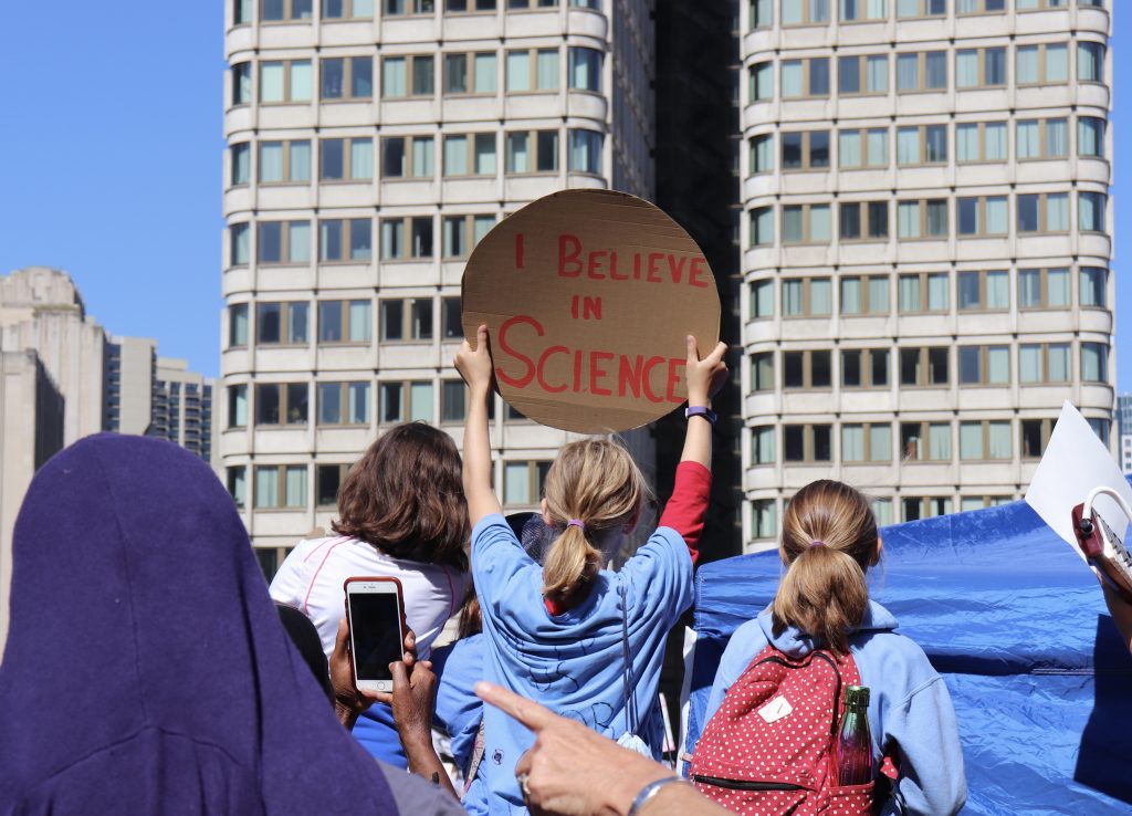 Protestors showed their support for climate change scientists at the Climate Strike in Boston. Photo by Eileen O'Grady.