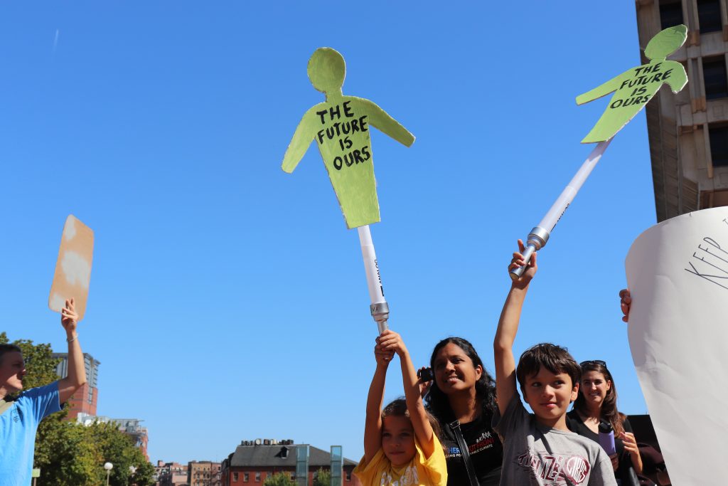 Students raised creative banners and signs at the Climate Strike. Photo by Eileen O'Grady.