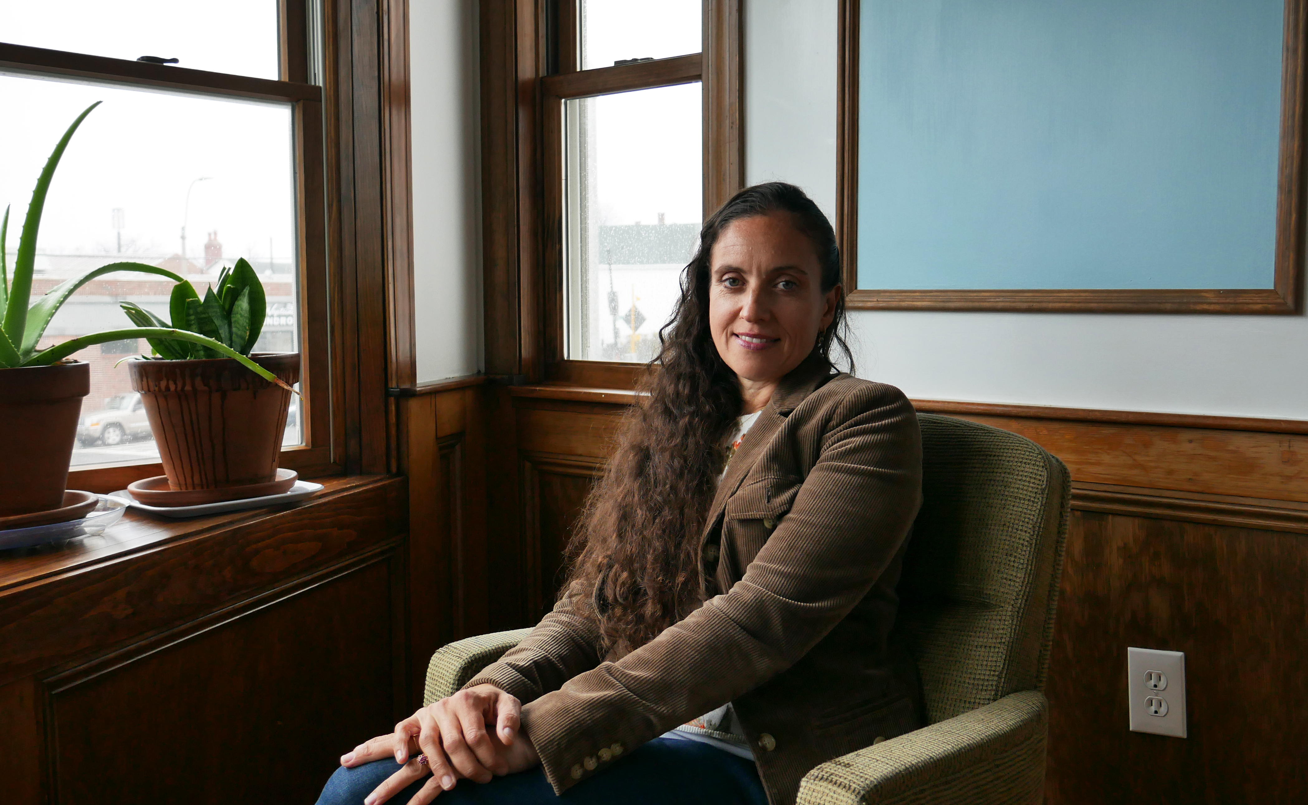 Magdalena Ayed, executive director of the Harborkeepers, sits in a conference room in her East Boston building. Photo by Jordan Erb.