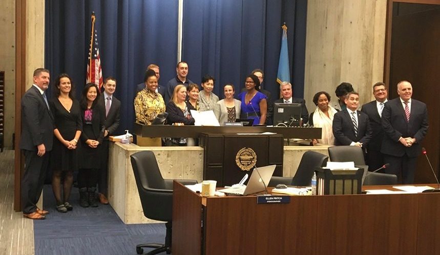 Councilors stand with Jason Gallagher, the principle of Harvard-Kent Elementary School, who secured a grant for the school. Photo by Joseph Handel.