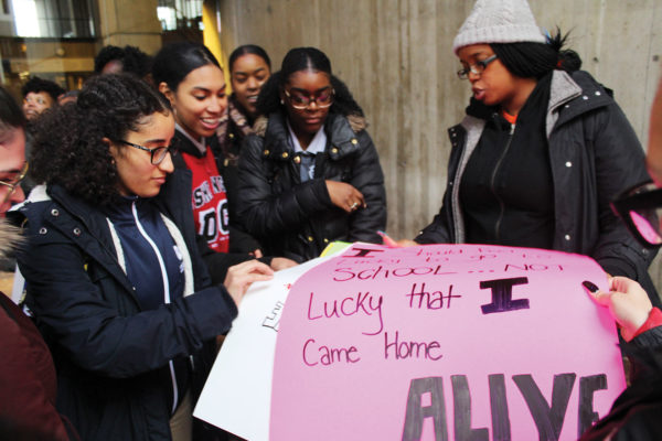 Monica Cannon-Grant hands out posters to students outside City Hall at "Die-in protest" in November 2018. Photo by Catherine McGloin.