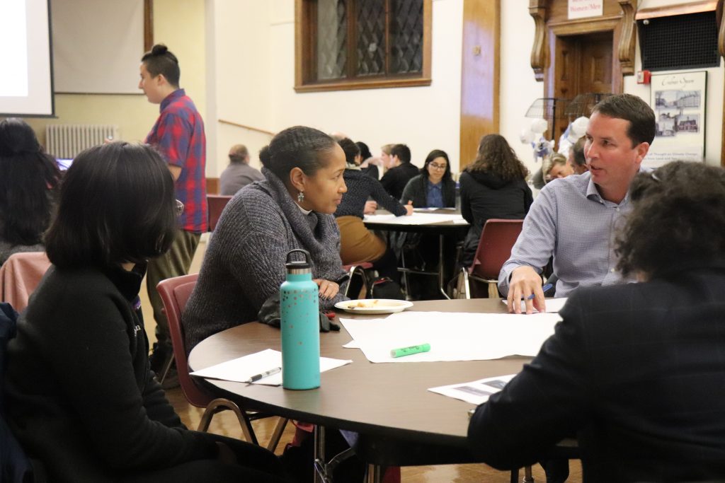 Later in the evening, attendees formed smaller groups to discuss climate change prevention ideas that would work in their communities. Photo by Eileen O'Grady.