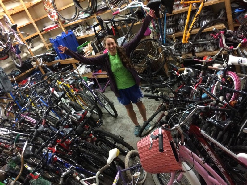 A volunteer stands in CommonWheels' storage facility until they were forced to relocate. Photo courtesy of CommonWheels' Facebook page.