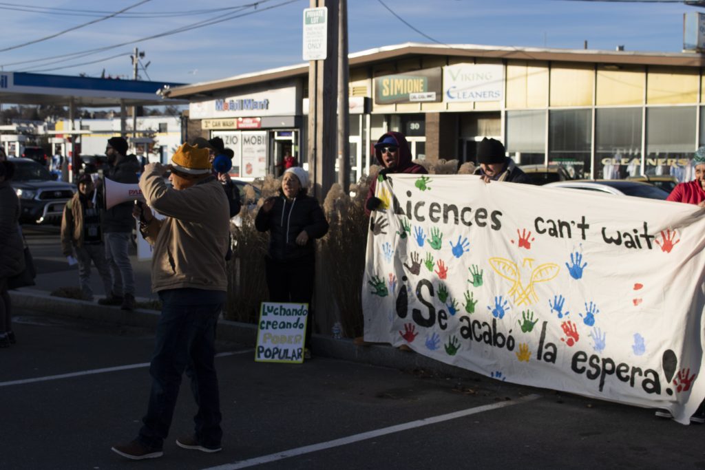 Marchers move through the streets of Winthrop with their banners. Photo by Elizabeth Torres.