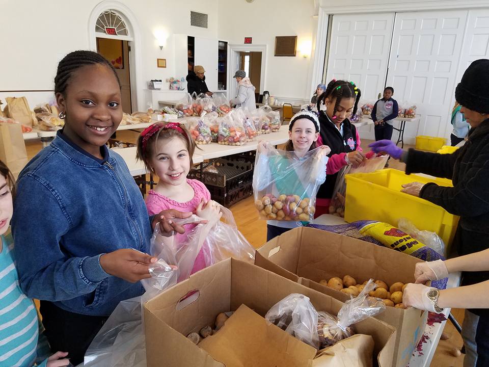 Girl Scouts help people buy groceries at one of Fair Foods' two-dollar-a-bag food sites. Photo by Gene Thorpe.