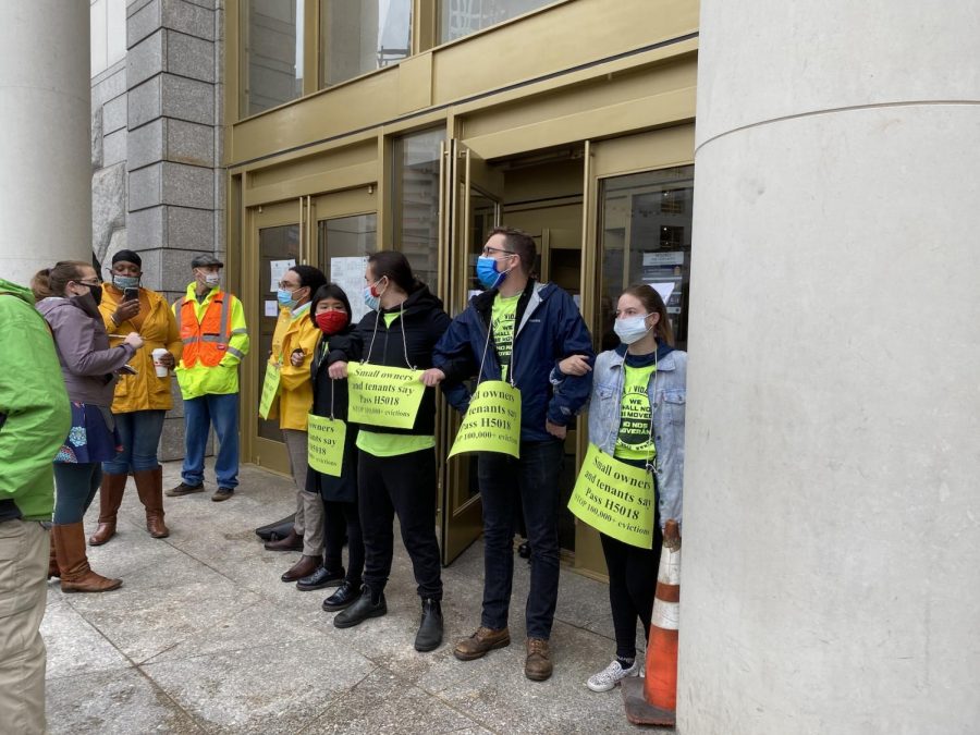 Protesters locking arms to block the entrance to Boston’s Eastern Housing Court