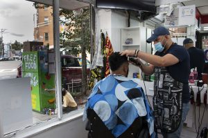 Despite the pandemic, barbers are still cutting and styling at D’Friends Barber Shop in Jamaica Plain. The Community Fridge can be seen from the inside of the shop with Northeastern student Talja Ketchum painting vibrant rainbows and flowers onto its exterior. The barbers are enthusiastic about the new initiative right outside their door. “My best friend gets a haircut at this barbershop all the time, so he put me in contact with the owner,” said Josiel Gonzalez, a co-founder and main organizer for the JP fridge. Jay Valeria, 24, has been a barber at D’Friends for three years now. “There’s a lack of love and warmness [in the world],” explained Valeria. “I feel like this promotes love.”