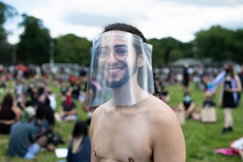 A man with a face shield attends the "Trans Resistance Vigil and March" at Franklin Park on June 13, 2020. Held in lieu of and on the 50th anniversary of Boston Pride March supporters gather to celebrate lives and rights of transgender people.