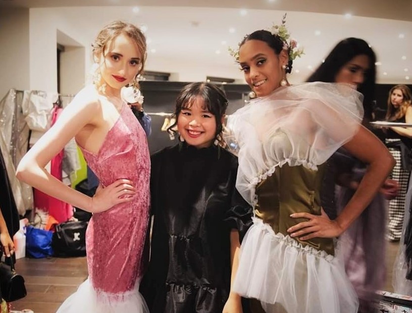 Gunes Wong Grenon (middle) poses with models Chelsey Anger and Massiel in dresses she designed. Courtesy of Gunes Wong Grenon..