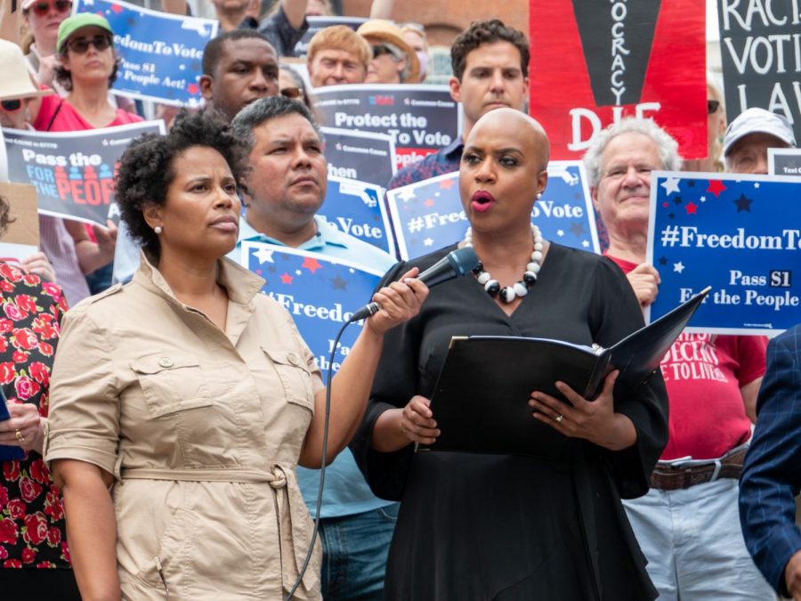 Tanisha Sullivan held the microphone for Congresswoman Ayanna Pressley as she delivered the keynote address from the steps at the corner of the Boston Common, near the intersection of Beacon and Park Streets.