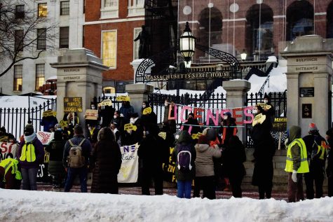 Members of Cosecha and Never Again Action Boston hold signs demanding licenses for all as they protest in front of the Massachusetts State House on Monday, Jan. 31, 2022. 