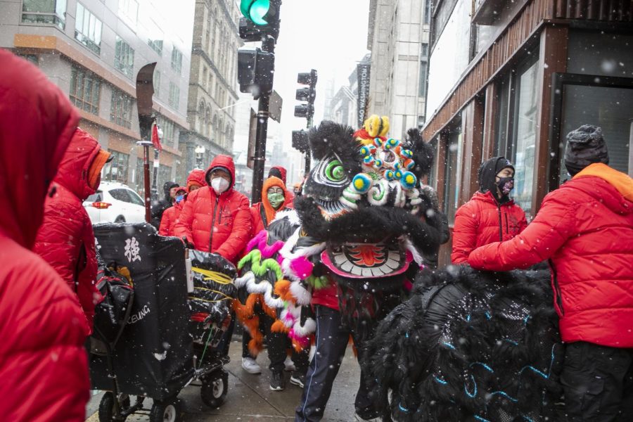 A dragon makes its way down the street of Bostons Chinatown during the Lunar New Year celebration. Many clear the path so the snowy walk is easier.