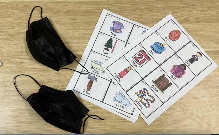Photo of a mask and childrens learning sheet.