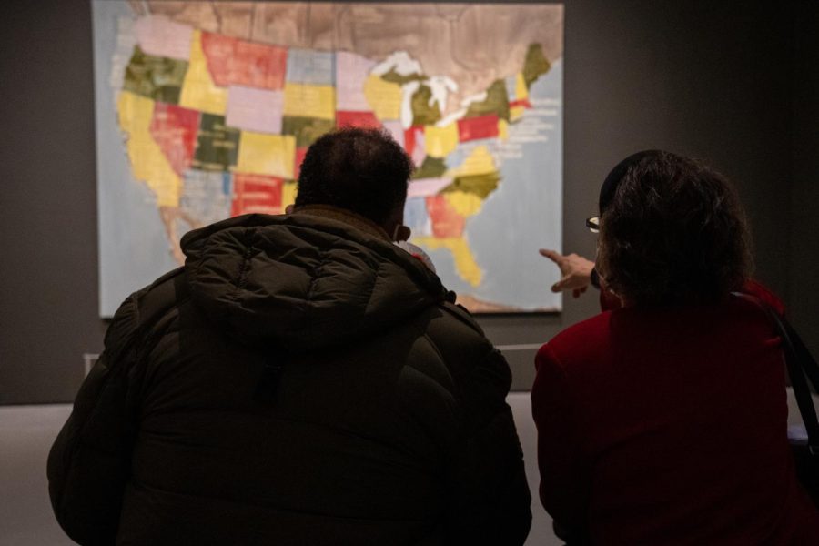 Two visitors to the Museum of Fine Arts Boston in February discussed the exhibited mixed media work “Tribal Map,” by Jaune Quick-to-See Smith. (Photo: Taylor Blackley)