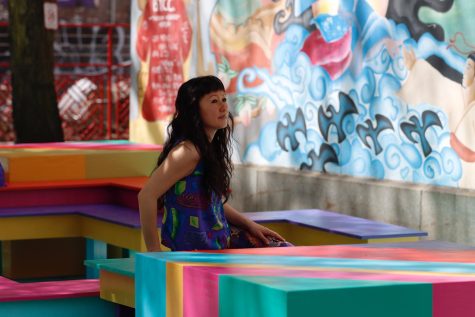 Cheryl Wing-Zi Wong, NY -based artist and trained architect, sitting on her latest installation, YEAR OF THE TIGER, at Mary Soo Hoo Park in Chinatown, Boston on May 14, 2022.