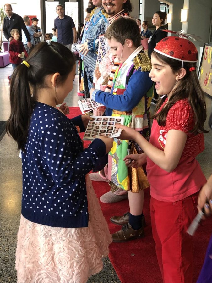 Sherri Ettinger’s daughter, Maia (right), 8 at the time, signs autographs during the Wheelock Family Theater’s 2019 performance of James and the Giant Peach. Photo courtesy of Sherri Ettinger