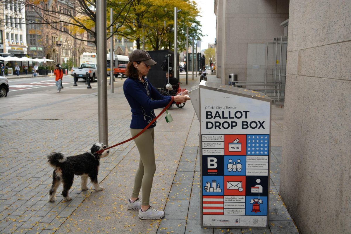 (FILE) Nov. 1, 2024 — Ashley Zeller casts her ballot at the official drop box outside the Boston Public Library in Copley Square on the final day of early voting. Ward 5, Precinct 7 voters turn out for the last opportunity to submit their ballots ahead of Election Day. Photo by Martina Chiara.