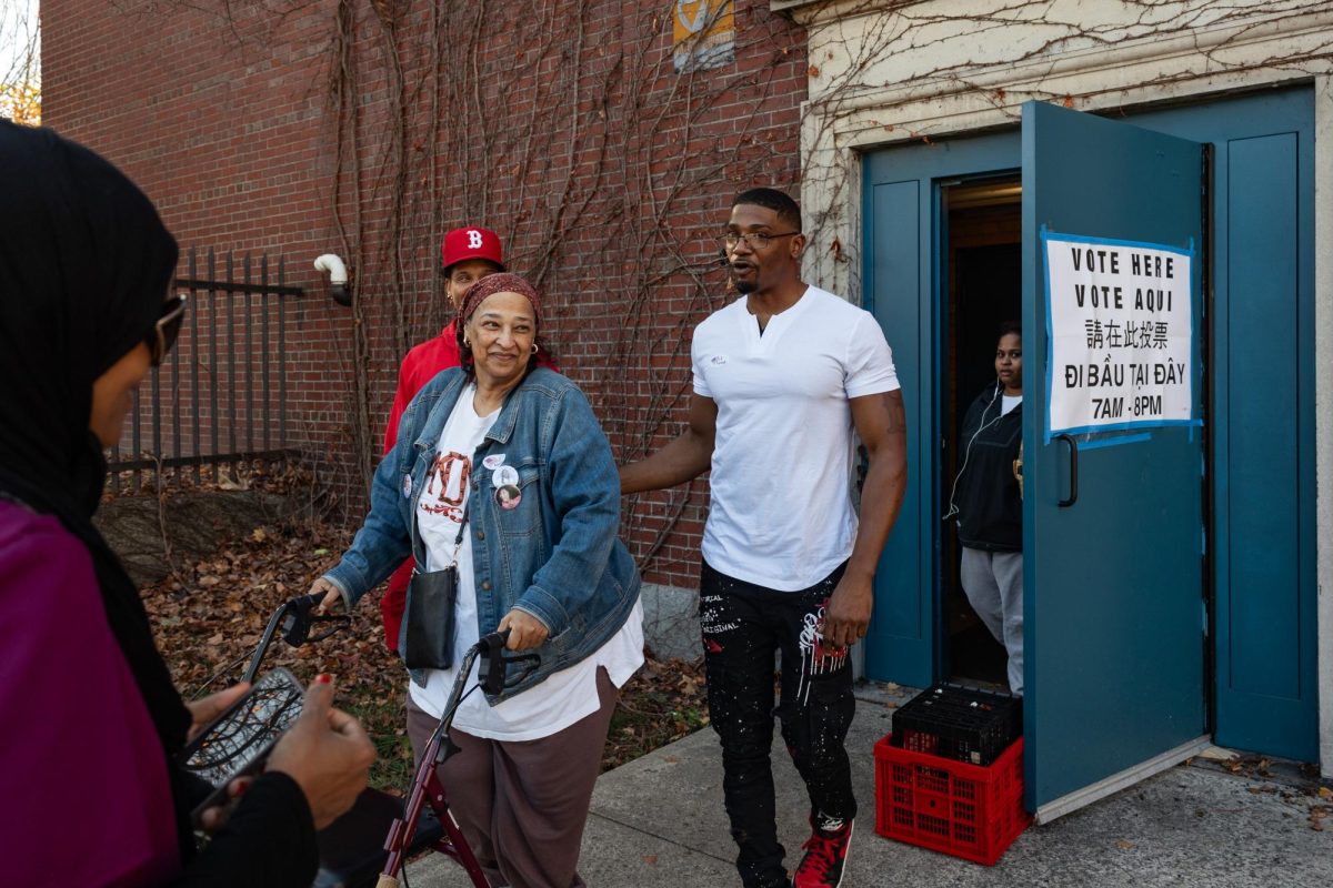 A woman smiles as she leaves a polling center in Roxbury on Nov. 5, 2024.