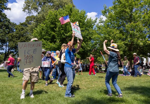 Demonstrators display signs and dance at the Rage Against The Regime festival on August 2 in Cambridge.