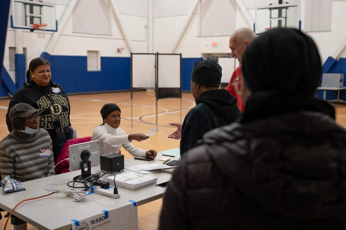 Poll workers at The Dewitt community center in Roxbury help voters. 