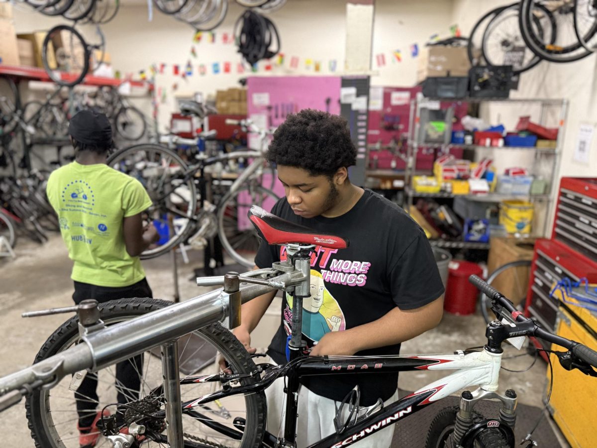 A youth apprentice works on a donated bicycle at Bikes Not Bombs’ workshop in Jamaica Plain. The nonprofit repairs and redistributes bikes locally and internationally in partnership with young people.