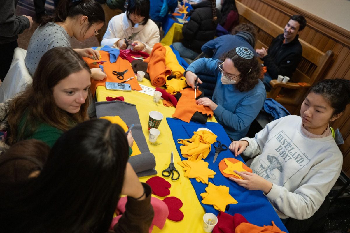 Volunteers cut out shapes to customize their blankets, Jan. 19, 2026.