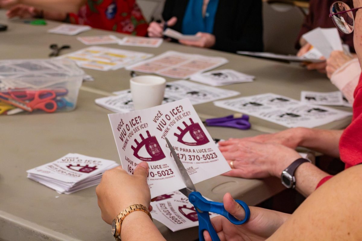 Volunteers at Boston's Old South Church cut apart handouts with information for immigrants.