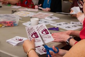 Volunteers at Boston's Old South Church cut apart handouts with information for immigrants.